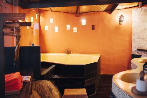 a bathroom with a bath tub and a sink at Koh Tao Cabana in Koh Tao