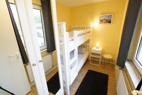 a small room with a bunk bed and a staircase at Ferienhausanlage Flessenow in Flessenow