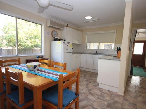 a kitchen with a table and chairs and a refrigerator at North Haven Sea Breeze in North Haven