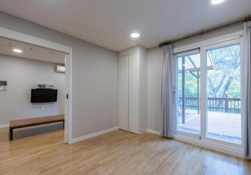 an empty living room with a sliding glass door at CAMP Jirisan Parkview in Gurye