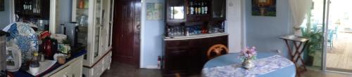 a living room with a table and a bar at Rollezz Villas Beach Resort in Old Bight