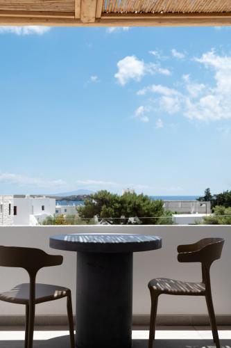a table and two chairs in front of a window at Drios Luxury Studios in Drios