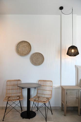 a table and two chairs in a room at Drios Luxury Studios in Drios