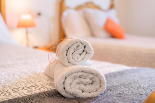 a stack of towels sitting on top of a bed at Bellavista Port de Soller in Port de Soller