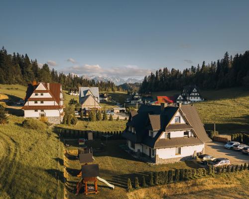 an aerial view of a village with houses and cars at Gościniec Grandel in Bukowina Tatrzańska