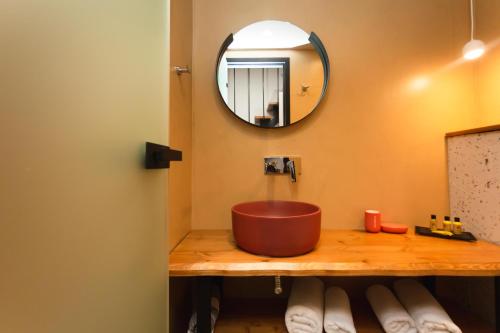 a bathroom with a copper sink and a mirror at Amoessa Boutique - Adults Only in Polykhrono