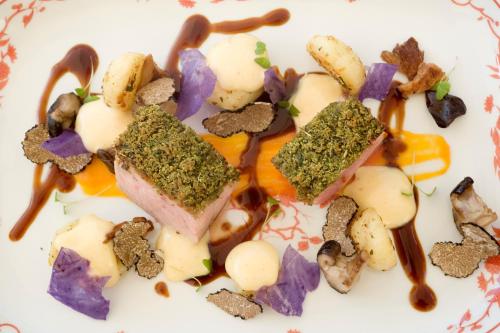 a plate of food with meat and vegetables on it at Cap Rocat, a Small Luxury Hotel of the World in Cala Blava