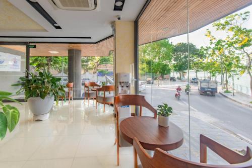 a restaurant with tables and chairs and a view of a street at 22Land Moon West Lake in Hanoi