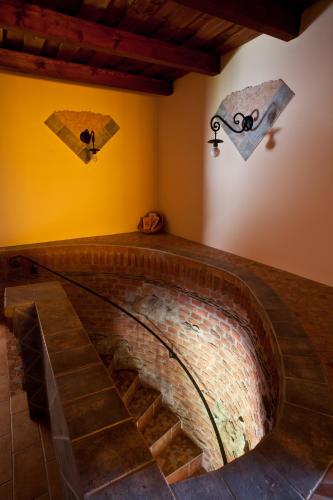 a brick staircase in a room with kites on the wall at St.Michael Panzió Lovaspark in Vasszentmihály