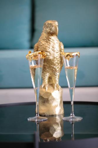 a statue of a bird with two champagne glasses at Iphimedeia Luxury Hotel & Suites in Naxos Chora