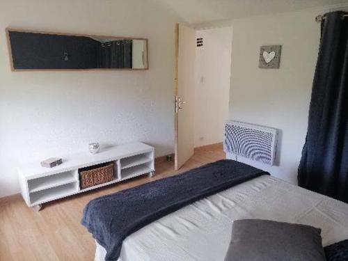 ein Schlafzimmer mit einem Bett mit einer blauen Decke darauf in der Unterkunft Plénitude in Sérignan