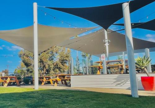 a white pavilion with picnic tables and tables at Lake Mulwala Hotel in Mulwala