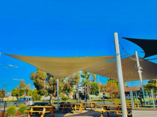 a group of picnic tables under a canopy at Lake Mulwala Hotel in Mulwala