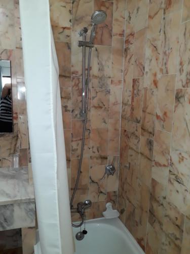 a bathroom with a shower and a bath tub at Salema Beach Apartment in Salema