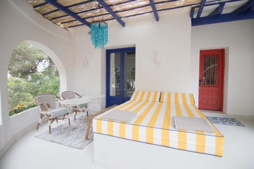 a bedroom with a bed and a table and chairs at Quinta la Sal in Jávea