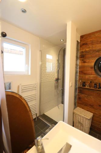 a bathroom with a white sink and a shower at Maison du Lys en Layon in Les Cerqueux-sous-Passavant