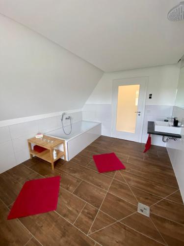 a kitchen with red mats on the floor and a sink at Ferienwohnung Dörrwies in Sankt Wendel