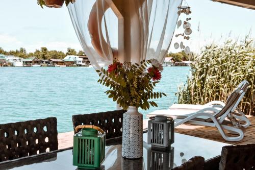 a table with a vase with flowers on it at Sojenica Ivona in Ulcinj
