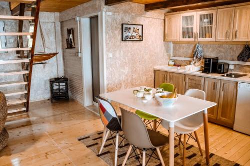 a kitchen with a white table and chairs at Sojenica Ivona in Ulcinj