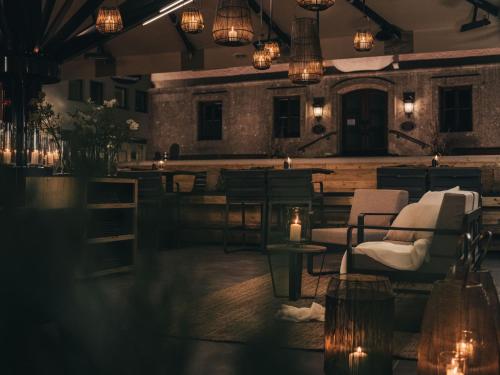 a room with chairs and tables and lights at VAYA Post Saalbach inklusive Joker Card in Saalbach Hinterglemm