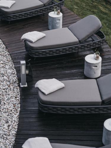 a group of pillows sitting on a wooden deck at VAYA Post Saalbach inklusive Joker Card in Saalbach Hinterglemm