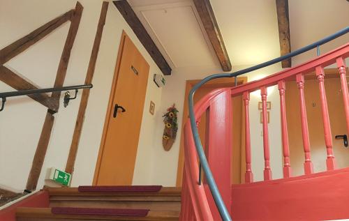a staircase in a house with a red door at Villa Hoffnung in Bad Elster