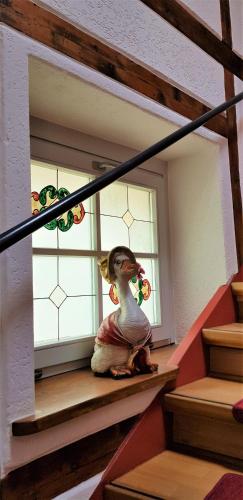 a little girl sitting on the stairs in front of a window at Villa Hoffnung in Bad Elster