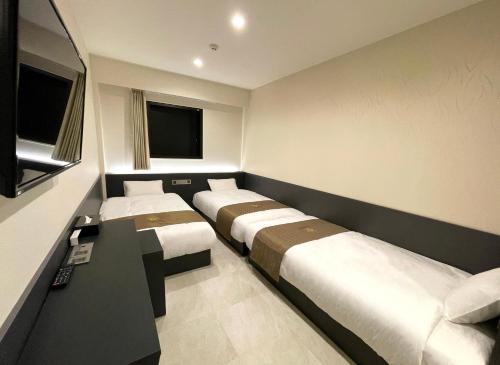 Tempat tidur dalam kamar di 対馬 central park hotel