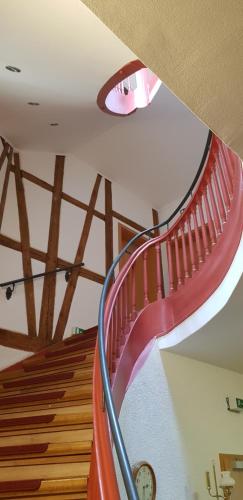 a spiral staircase in a building with a clock at Villa Hoffnung in Bad Elster
