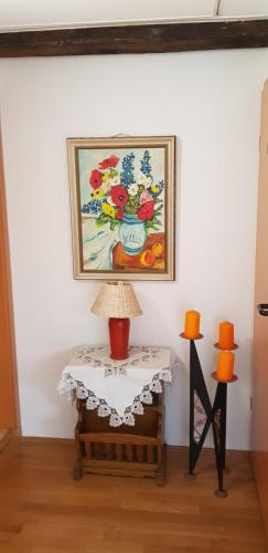 a painting of flowers in a vase on a wall at Villa Hoffnung in Bad Elster
