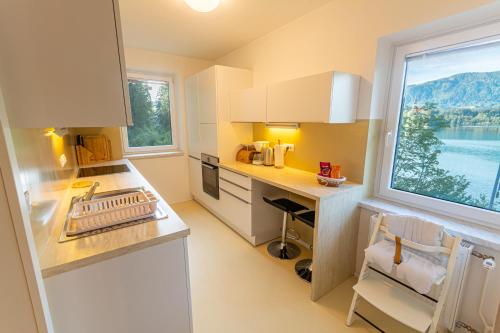 a small kitchen with a desk and a window at Lake Bled Apartments in Bled