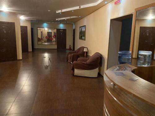 a lobby with chairs and a bar in a building at Гостинний маєток in Myla