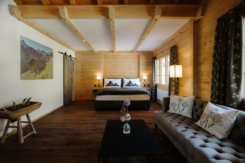 a hotel room with a bed and a couch at Bodehüttli in Adelboden