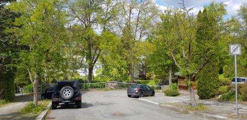 a car and a jeep parked in a parking lot at Villa Hoffnung in Bad Elster