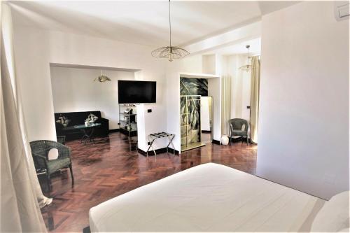 a living room with white walls and wood flooring at AN Deluxe Suites in Ancona