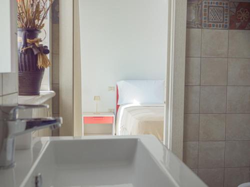 a bathroom with a white tub in a room at Rifugio di Puglia - Trulli & Dimore in Alberobello