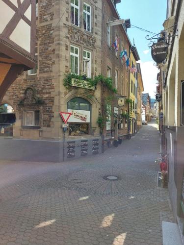 a brick building with a sign on a street at Pension Winnemuller in Cochem