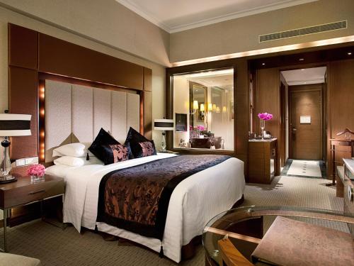 a hotel room with a large bed and a bathroom at Sofitel Macau At Ponte 16 in Macau