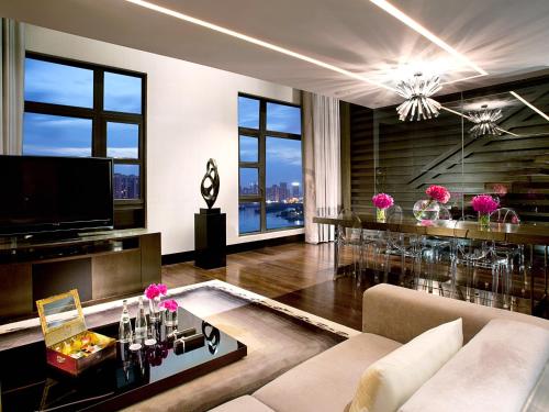 a living room with a couch and a table at Sofitel Macau At Ponte 16 in Macau