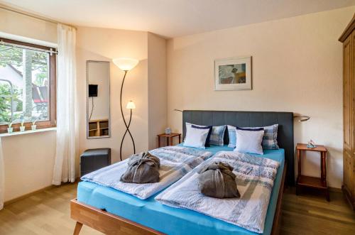a bedroom with a bed with two bags on it at Ferienwohnung Wolf Überlingen in Überlingen