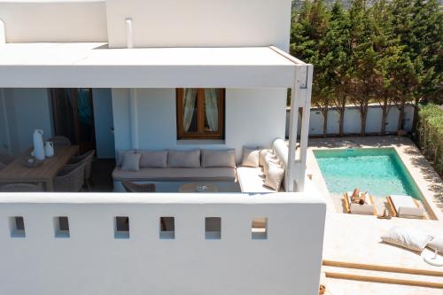 a living room with a couch and a swimming pool at Villa Alyko in Aliko Beach