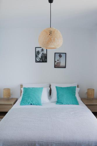 a bedroom with a white bed with blue pillows at Apartment Frana in Komarna