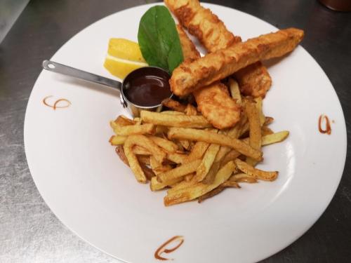a plate of food with french fries and dipping sauce at Campanile Toulouse Purpan in Toulouse