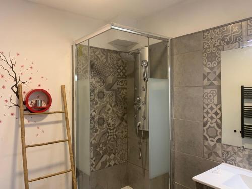 W łazience znajduje się prysznic ze szklanymi drzwiami. w obiekcie Hôtel U Passa Tempu w mieście Corte