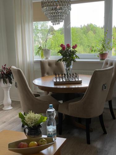 a dining room with a table and chairs and a window at My Kingdom in Gulbene