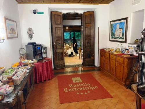 een kamer met een tafel en een rood kleed op de vloer bij Castello Cortevecchio in Gubbio
