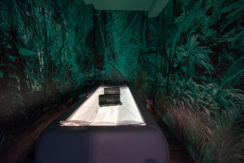 a room with a bed in the middle of a jungle at Castello Bonaria Wine & Spa Resort in Campiglia Marittima
