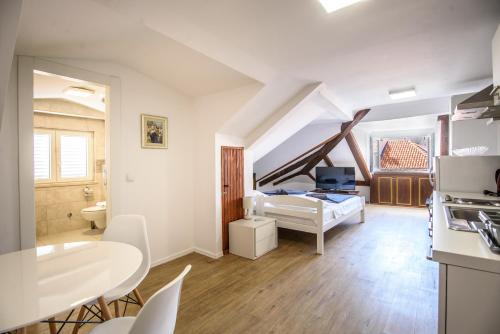 a living room with a bed and a dining room at Clarinet Old Town Dubrovnik in Dubrovnik