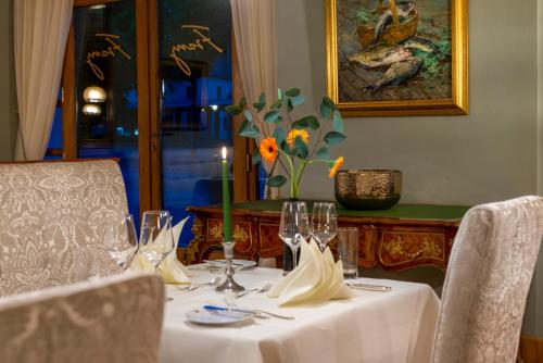 a table with a white table cloth and glasses on it at Best Western Premier Grand Hotel Russischer Hof in Weimar