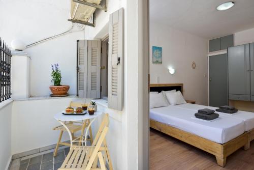a bedroom with a bed and a small table at Urban Studios Manos in Chania Town